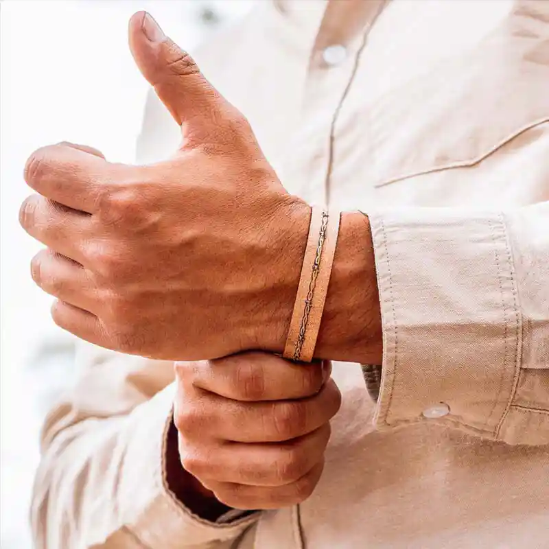 Man wearing a copper cuff bracelet with barbed wire detail and copper base